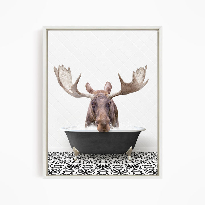 A moose with large antlers is sitting in a bathtub filled with water, creating a whimsical and humorous scene.
