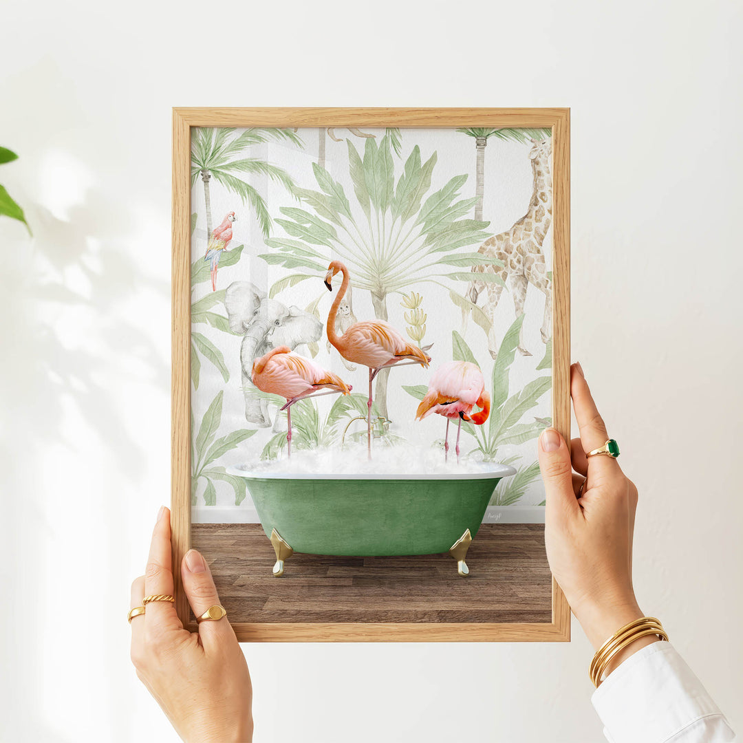 A person's hands are holding a framed picture of a green bathtub filled with water, surrounded by various colorful birds, including flamingos, and tropical plants.