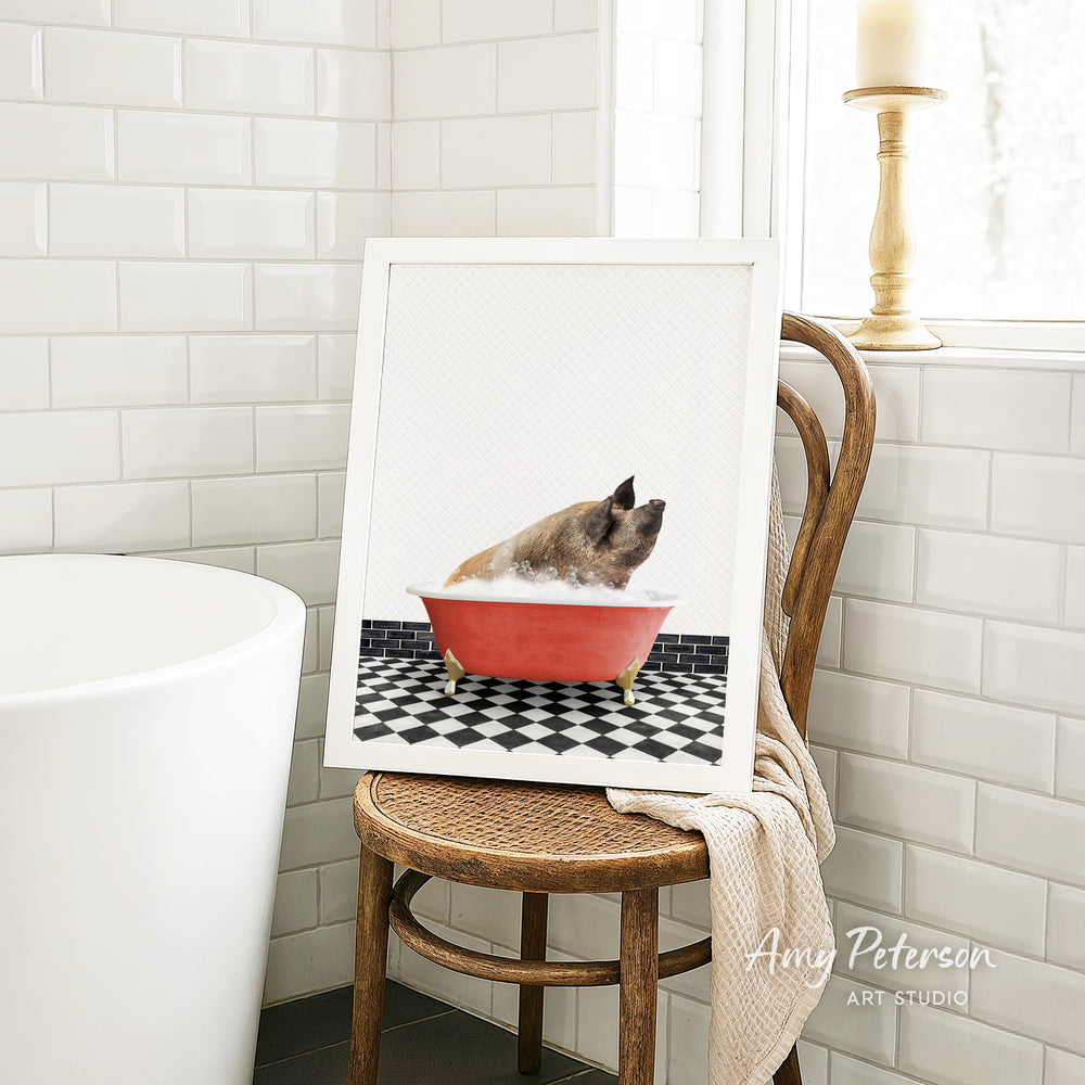 A framed image of a pig sitting in a red bathtub, surrounded by a black and white checkered floor, is displayed on a wooden chair in a bathroom setting.