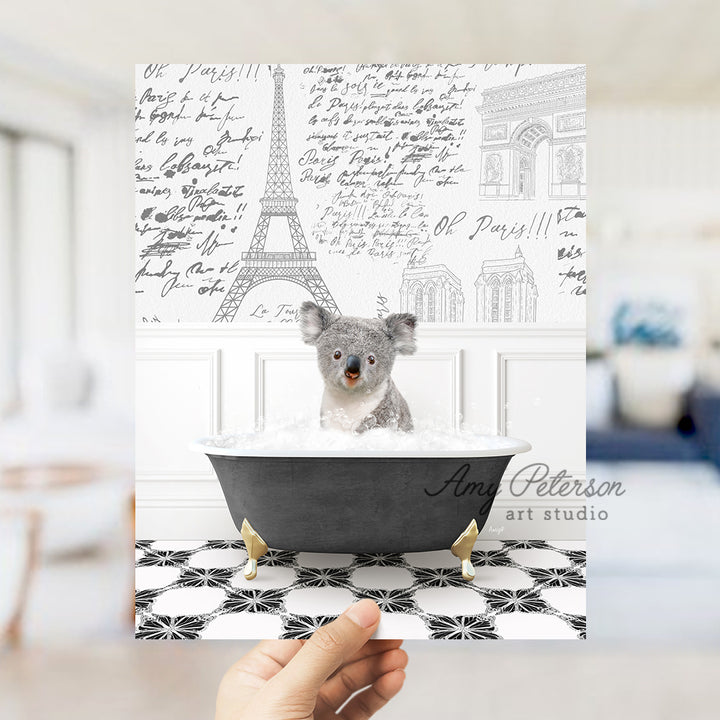 a person holding a card with a picture of a koala in a bathtub