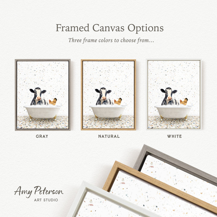 three framed canvas options featuring a cow sitting in a bathtub, with each option having a different frame color: gray, natural, and white.