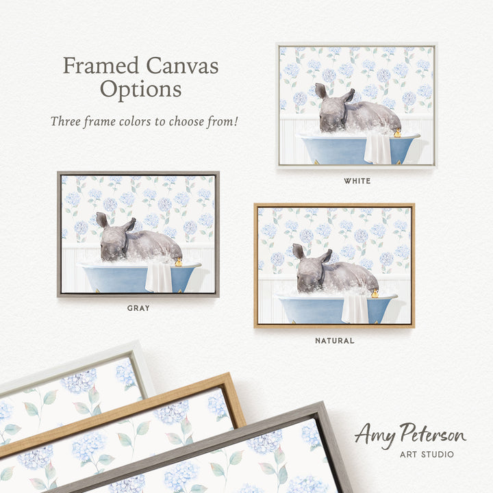 The image is a framed canvas with three different options for the color of the frame: white, gray, and natural. The canvas depicts a gray rabbit sitting in a blue bathtub, surrounded by blue flowers.