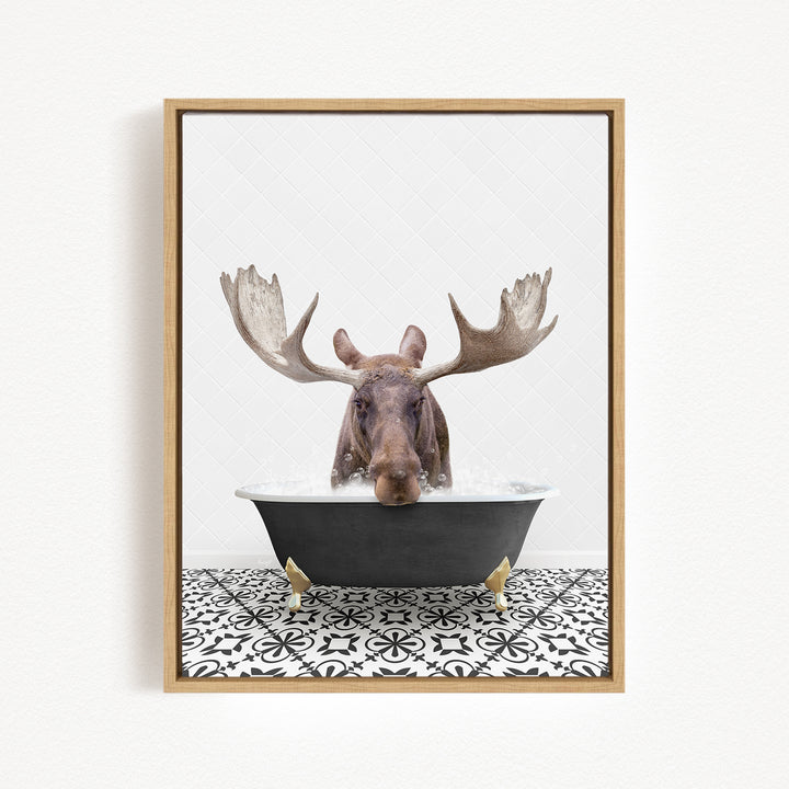 A moose with large antlers is sitting in a bathtub filled with water, creating a whimsical and humorous scene.