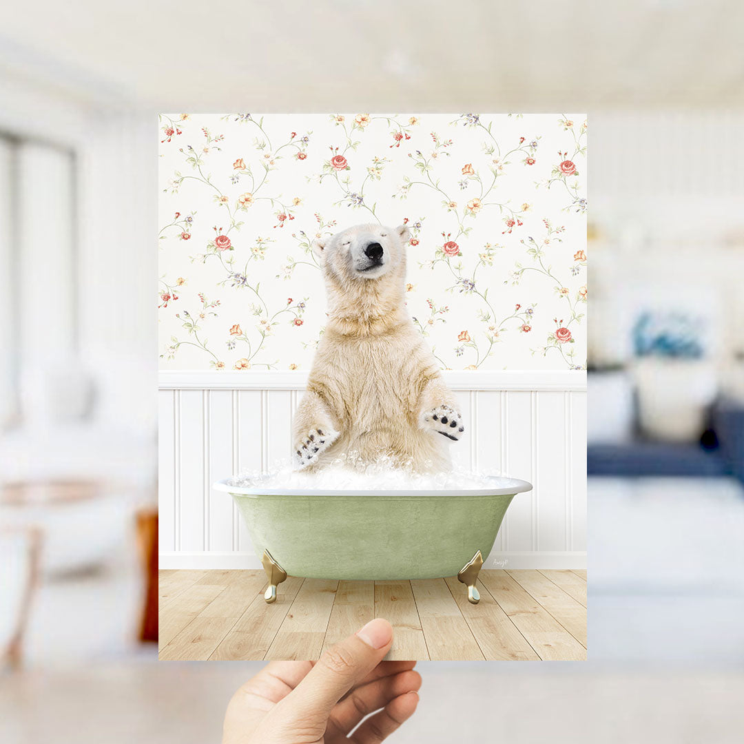 A polar bear sitting in a green bathtub filled with bubbles, surrounded by a floral patterned wall.