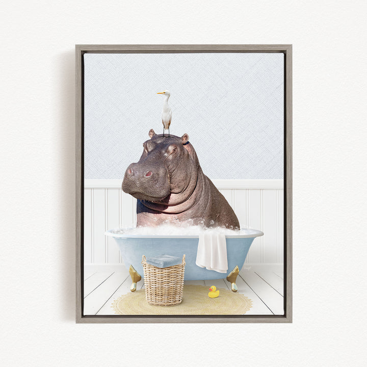 A hippopotamus sitting in a bathtub, with a bird perched on its head, and a basket of rubber ducks nearby.