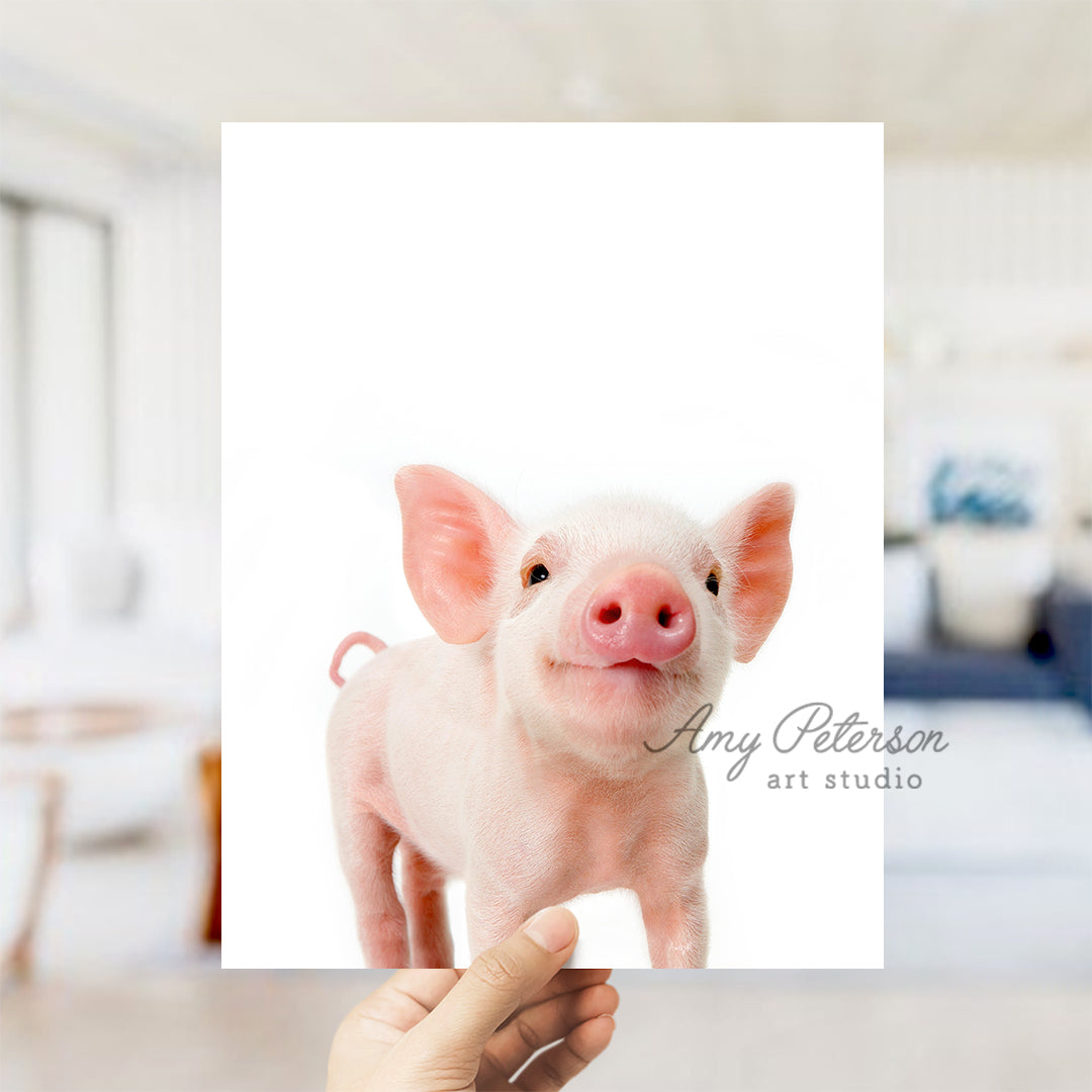 a person holding up a picture of a pig