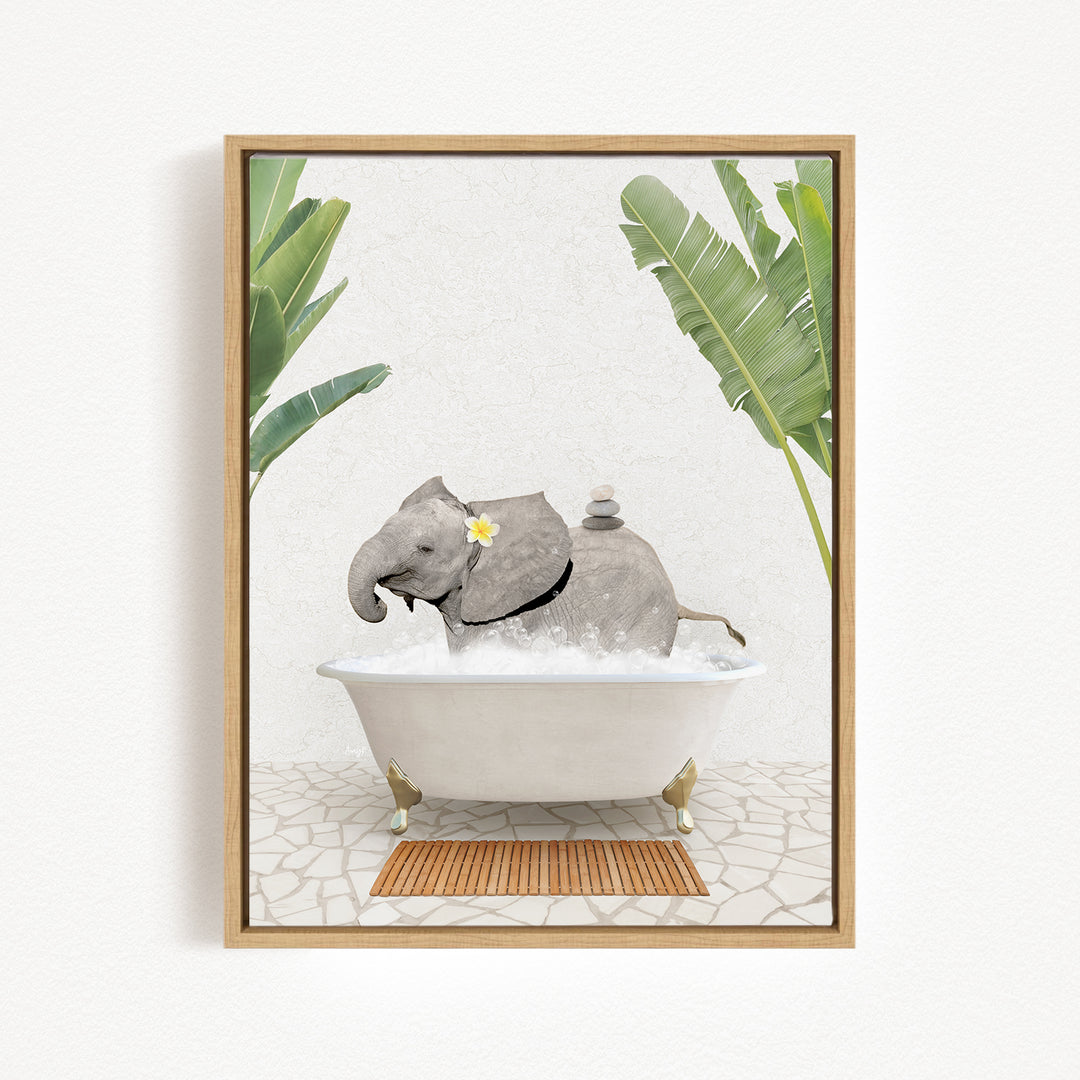 A gray elephant is sitting in a white bathtub filled with water, surrounded by green leaves and a wooden mat on the floor.