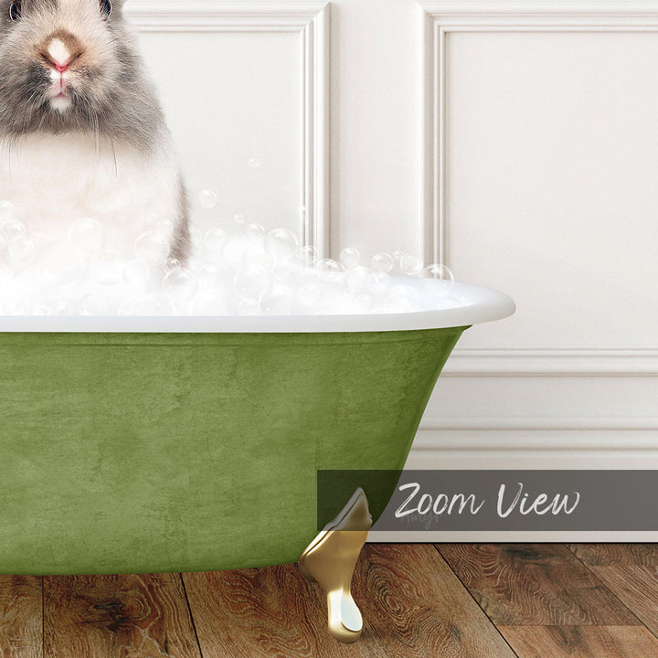 A fluffy white rabbit sitting in a green bathtub filled with bubbles, with a wooden floor visible in the background.