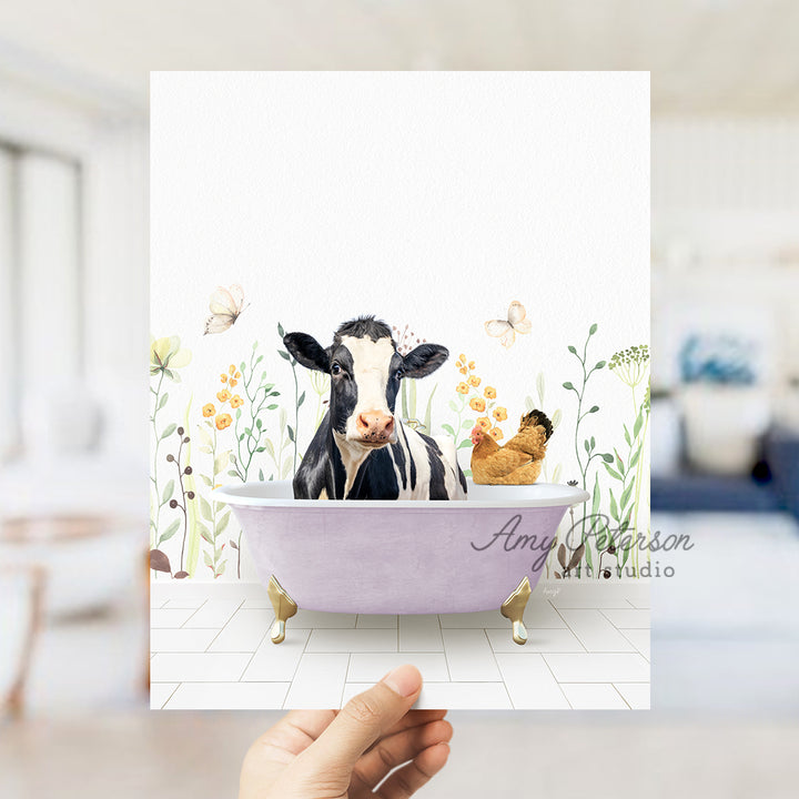 a person holding up a card with a picture of a cow in a bathtub