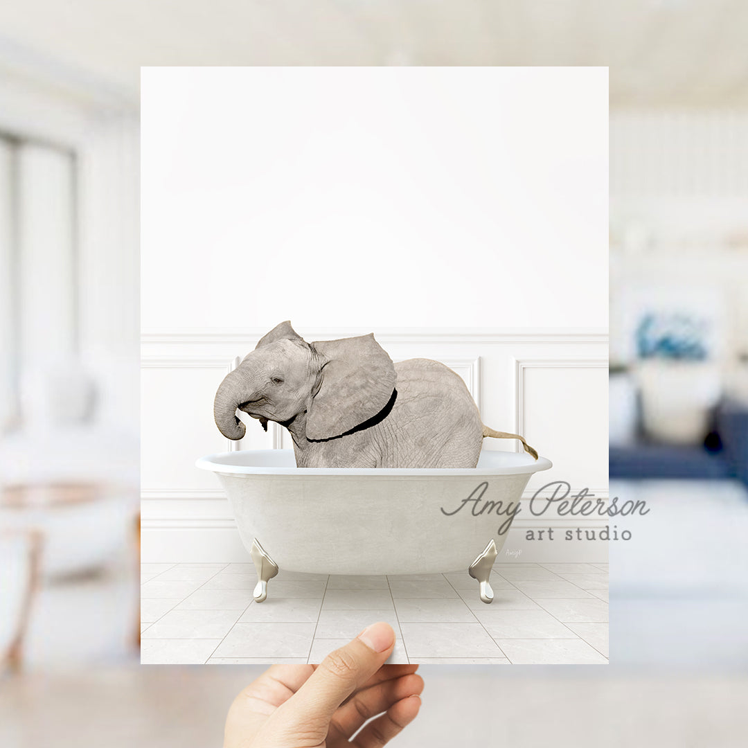 a hand holding a card with an elephant in a bathtub