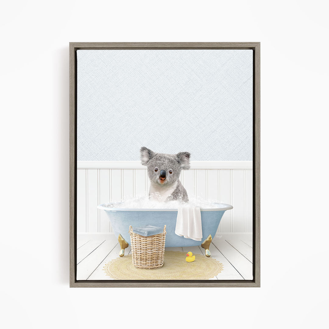 A koala bear sitting in a blue bathtub filled with water, surrounded by a yellow rubber duck and a basket.