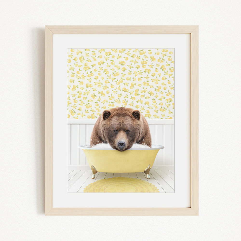 A brown bear is sitting in a yellow bathtub, surrounded by a yellow floral pattern on the wall behind it.