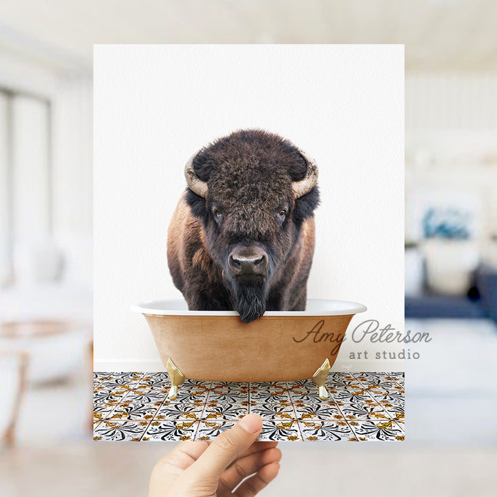 a person holding a card with a picture of a bison in a bathtub