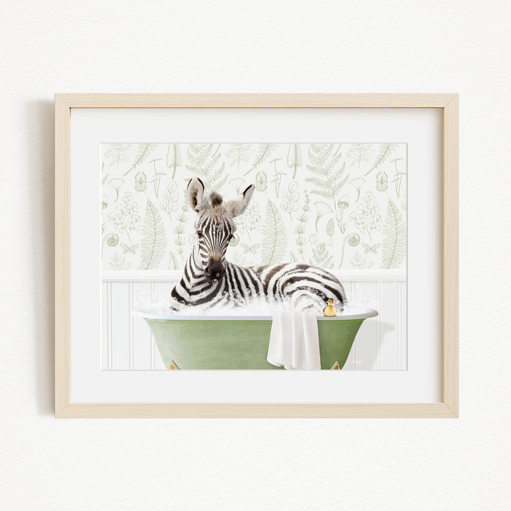 A zebra is sitting in a green bathtub filled with water, surrounded by a white towel and a yellow rubber duck.