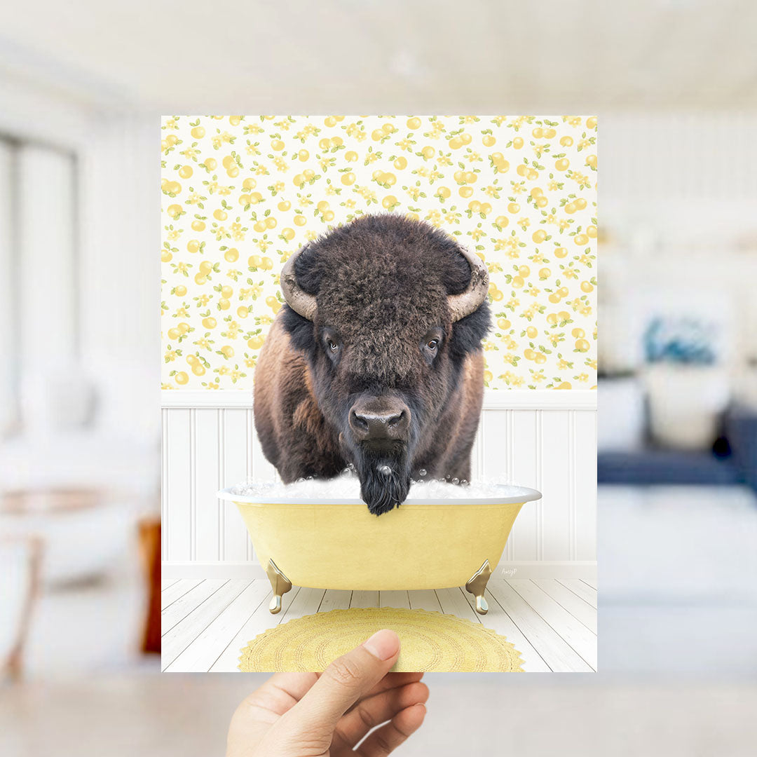 A buffalo with a long beard is sitting in a yellow bathtub, surrounded by a yellow and white floral pattern.
