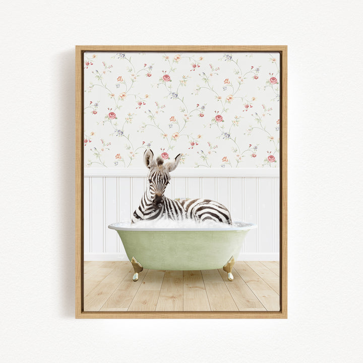 A zebra is sitting in a green bathtub, surrounded by a floral wallpaper.