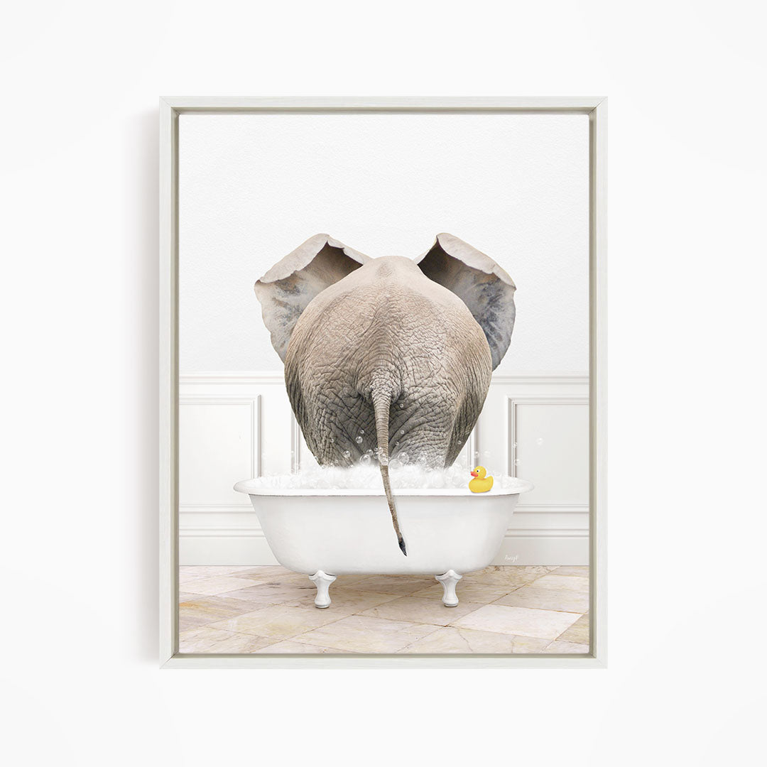 An elephant is standing in a white bathtub filled with water, with a rubber duck floating nearby.
