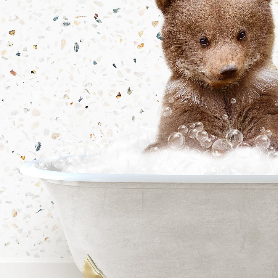 a brown bear sitting in a bath tub filled with bubbles