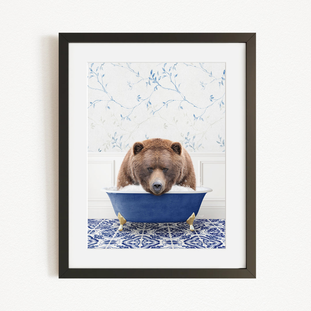 A brown bear is sitting in a blue bathtub, surrounded by a blue and white patterned rug and a floral wallpaper background.