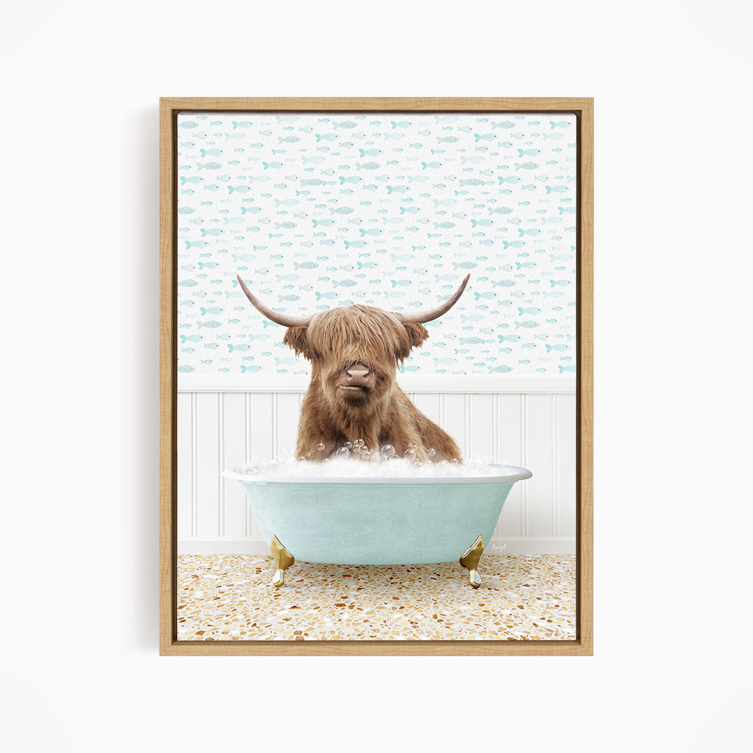 A brown cow with long horns is sitting in a light blue bathtub filled with bubbles, with a patterned wall behind it.
