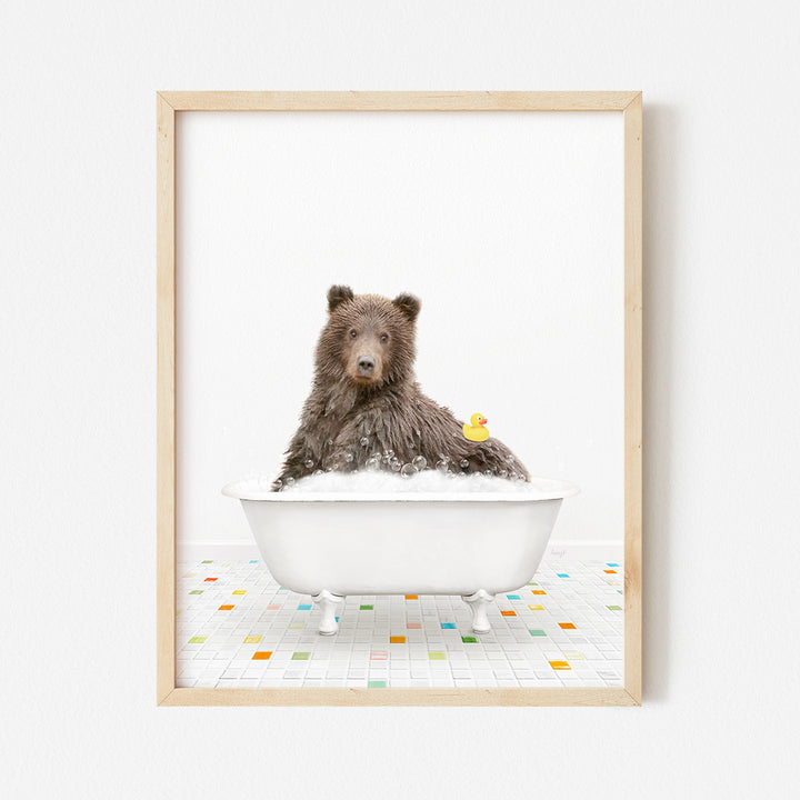 a brown bear sitting in a bathtub with a rubber duck