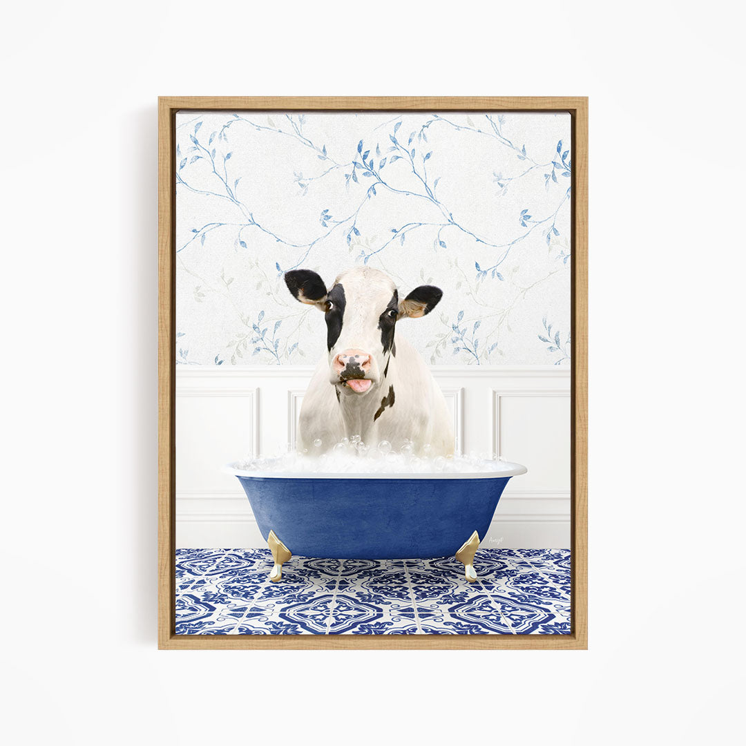 A black and white cow is sitting in a blue bathtub filled with water, surrounded by a blue and white patterned floor.