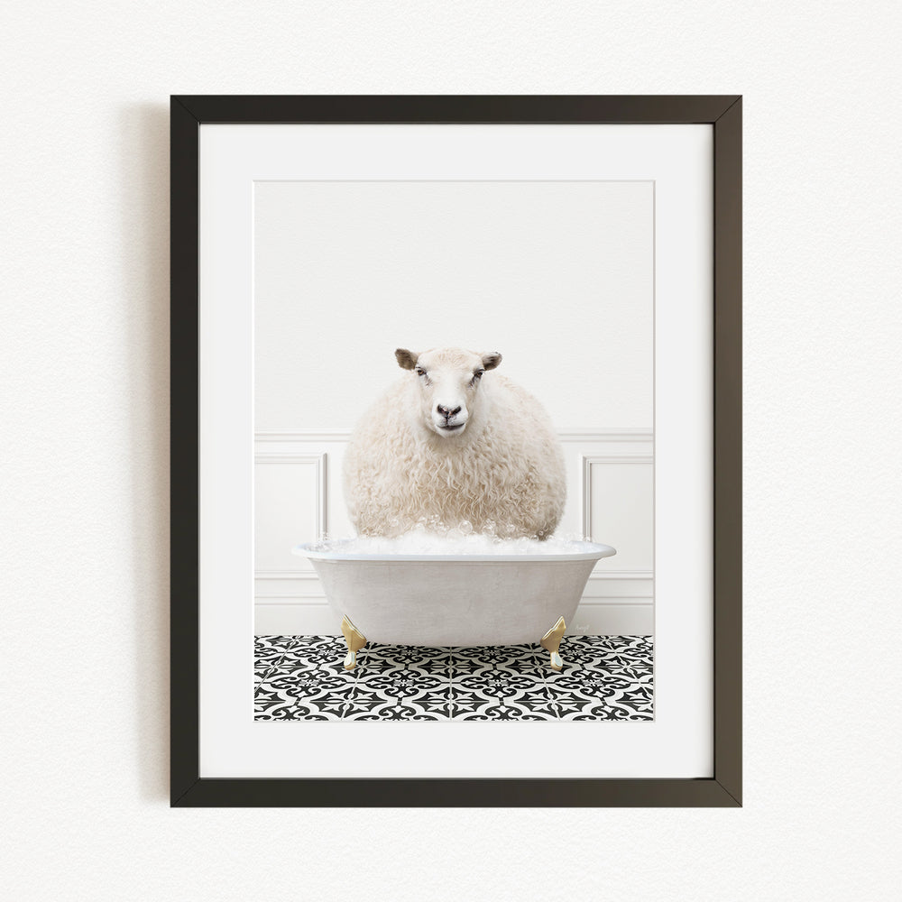 A fluffy white sheep sits in a white bathtub filled with bubbles, creating a whimsical and playful scene.