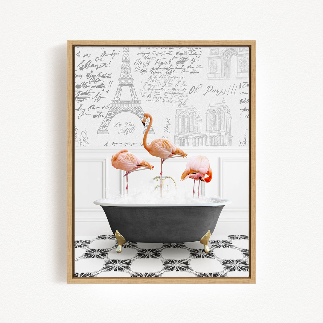 A framed image depicting three flamingos standing in a bathtub filled with water, with the Eiffel Tower and other Parisian landmarks visible in the background.