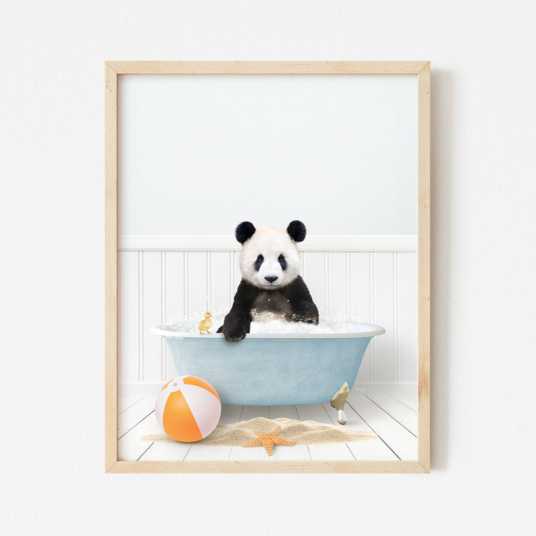 a panda bear sitting in a bathtub with a beach ball