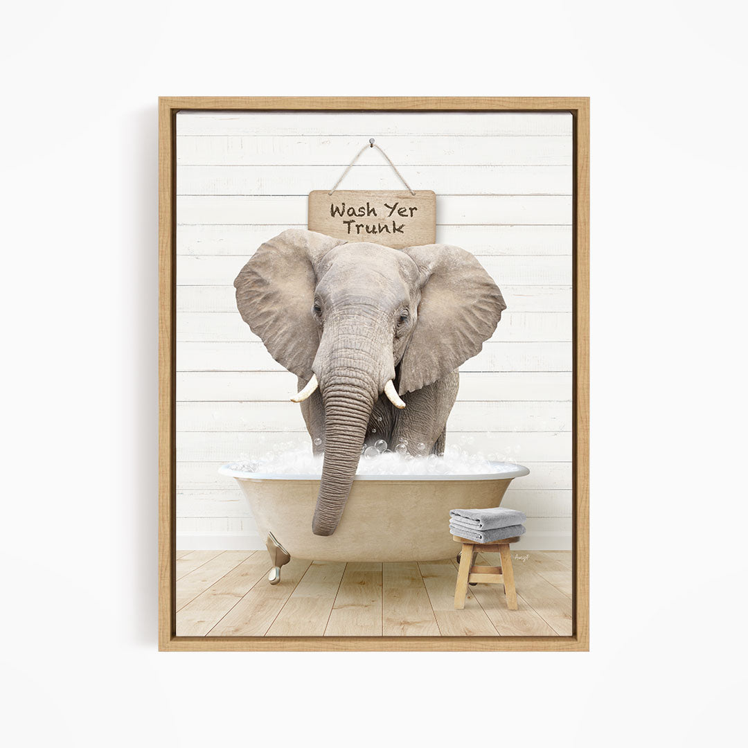 A gray elephant is standing in a bathtub filled with water, with a sign above it that says "Wash Your Trunk".