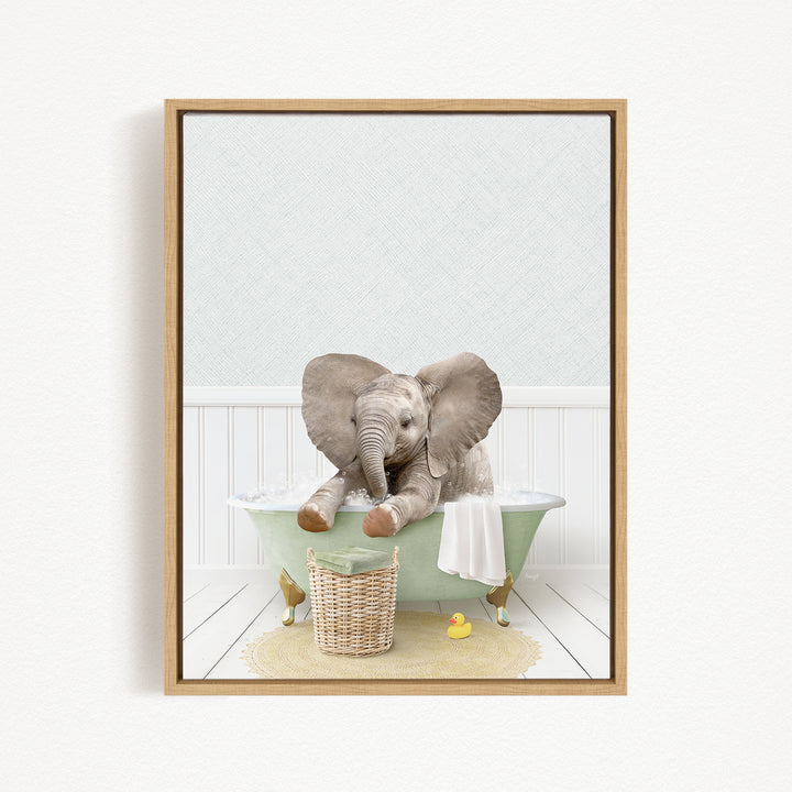 A baby elephant sitting in a green bathtub, surrounded by a basket of toys and a yellow rubber duck.