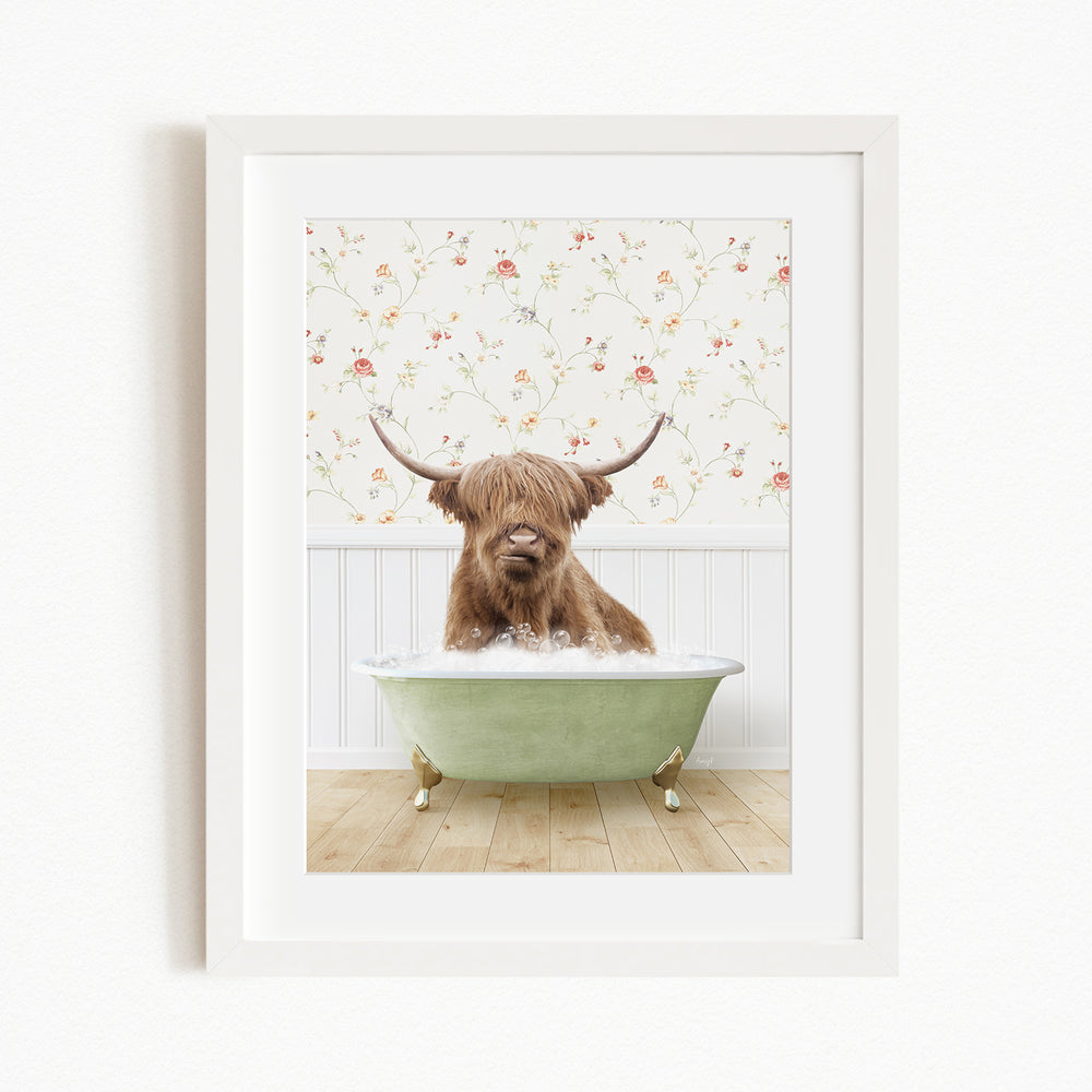 A brown cow with long horns is sitting in a green bathtub, surrounded by a floral wallpaper.