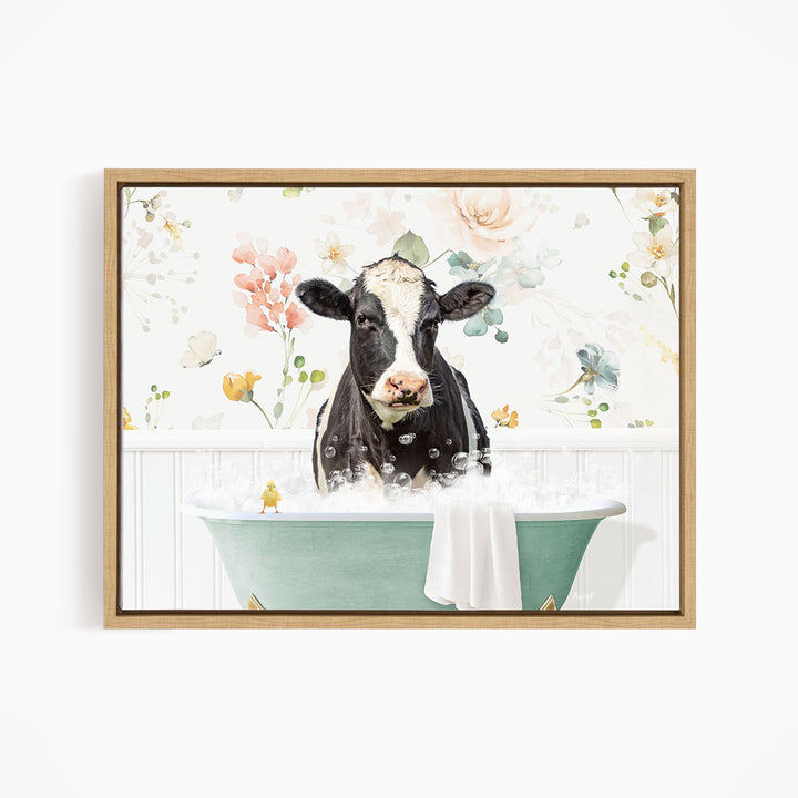 A black and white cow is sitting in a green bathtub filled with bubbles, surrounded by a floral wallpaper.