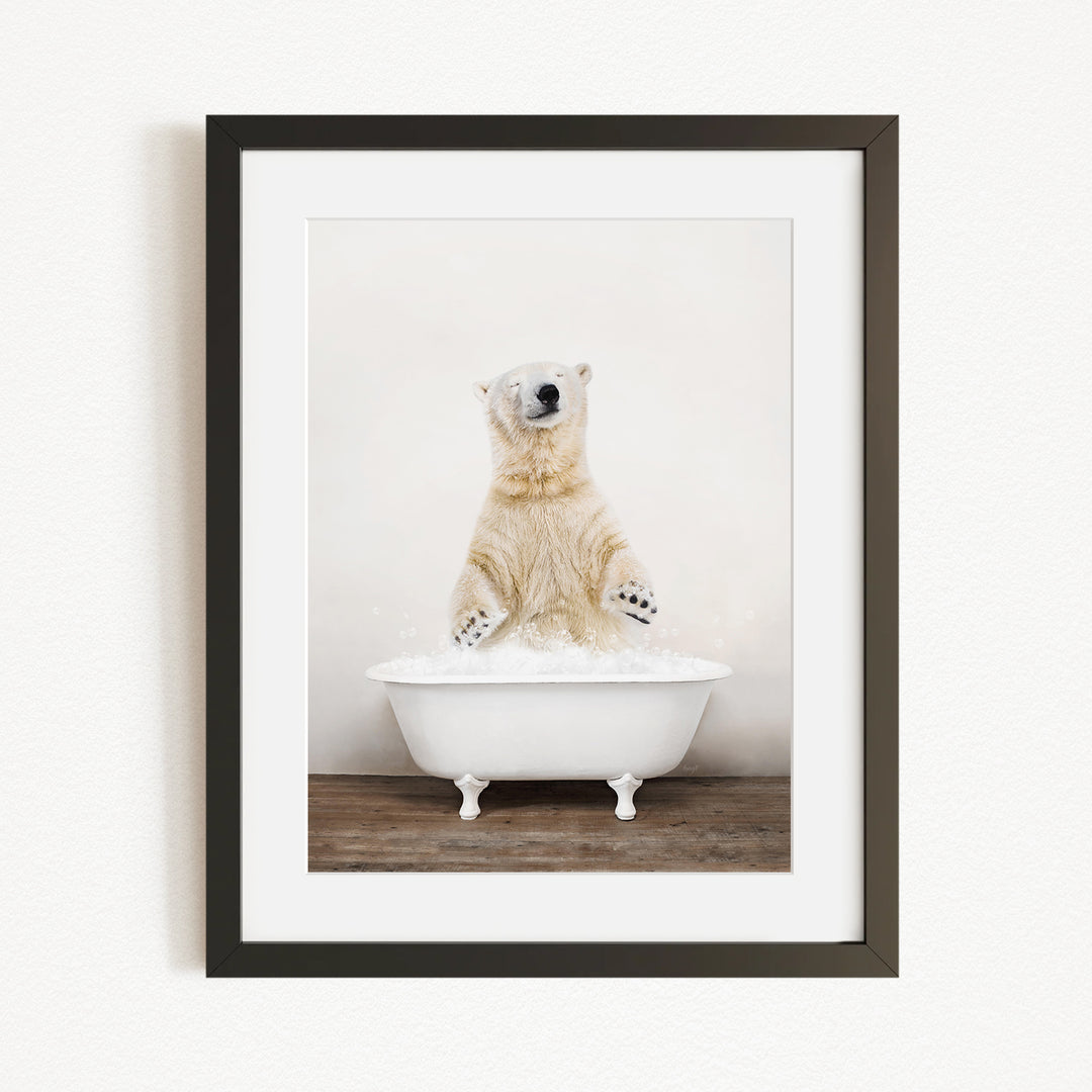 A polar bear standing in a white bathtub filled with water, appearing to be enjoying a bath.