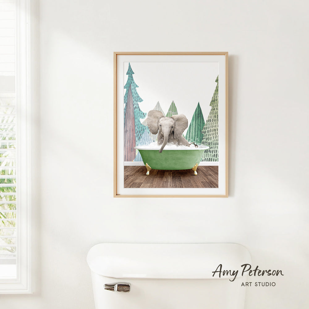 A framed painting of an elephant sitting in a green bathtub, surrounded by trees, is hanging on a white wall.
