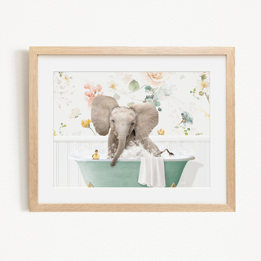 A baby elephant sitting in a green bathtub filled with bubbles, surrounded by a floral background.