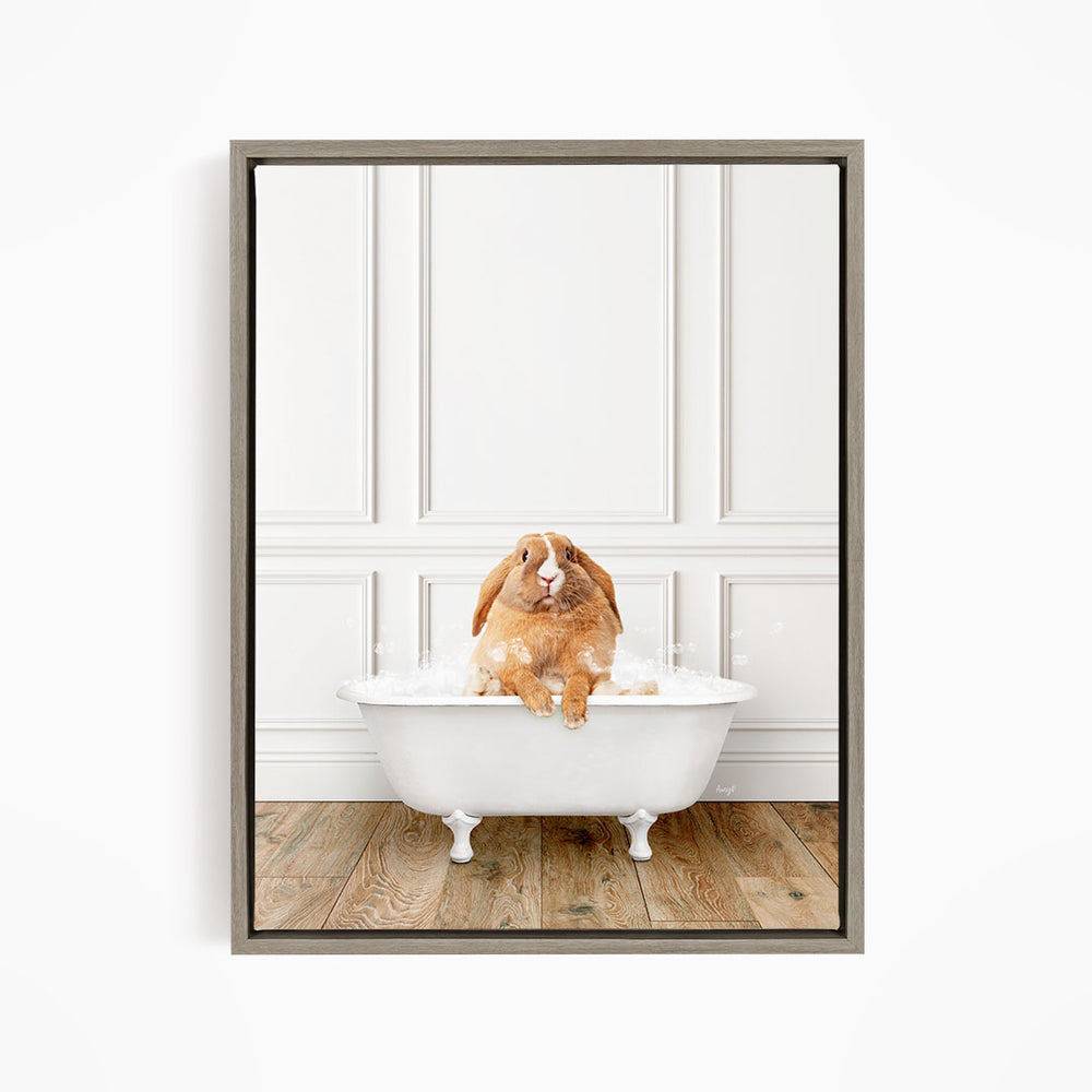 A brown rabbit sitting in a white bathtub filled with bubbles, looking directly at the camera.