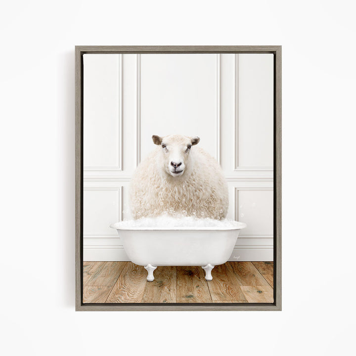 A fluffy white sheep sits in a white bathtub filled with bubbles, looking directly at the camera.