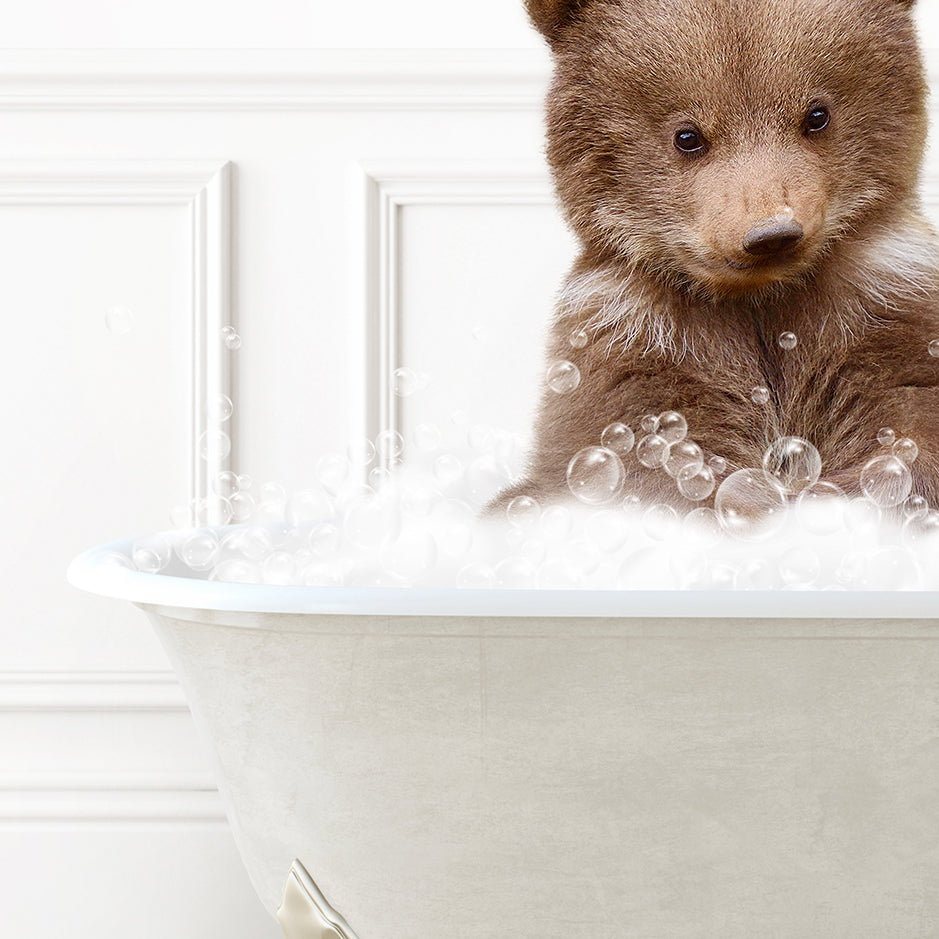 a brown bear sitting in a bath tub filled with bubbles