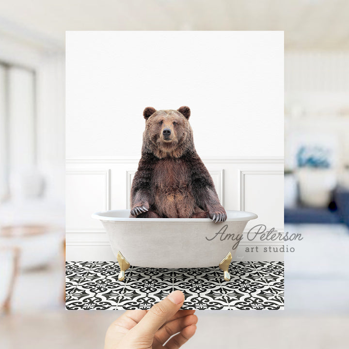 a person holding up a card with a bear in a bathtub