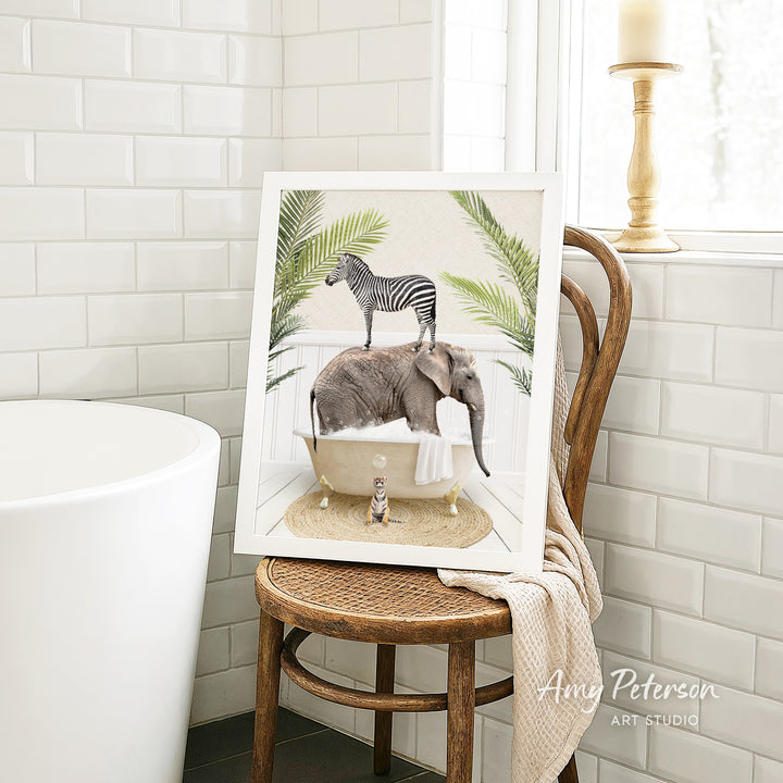 A framed image depicting a zebra standing on an elephant in a bathtub, with a cat sitting on the elephant's back.