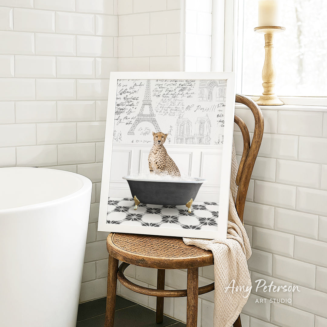 A framed image of a cheetah sitting in a bathtub, with a tiled wall and a window in the background.