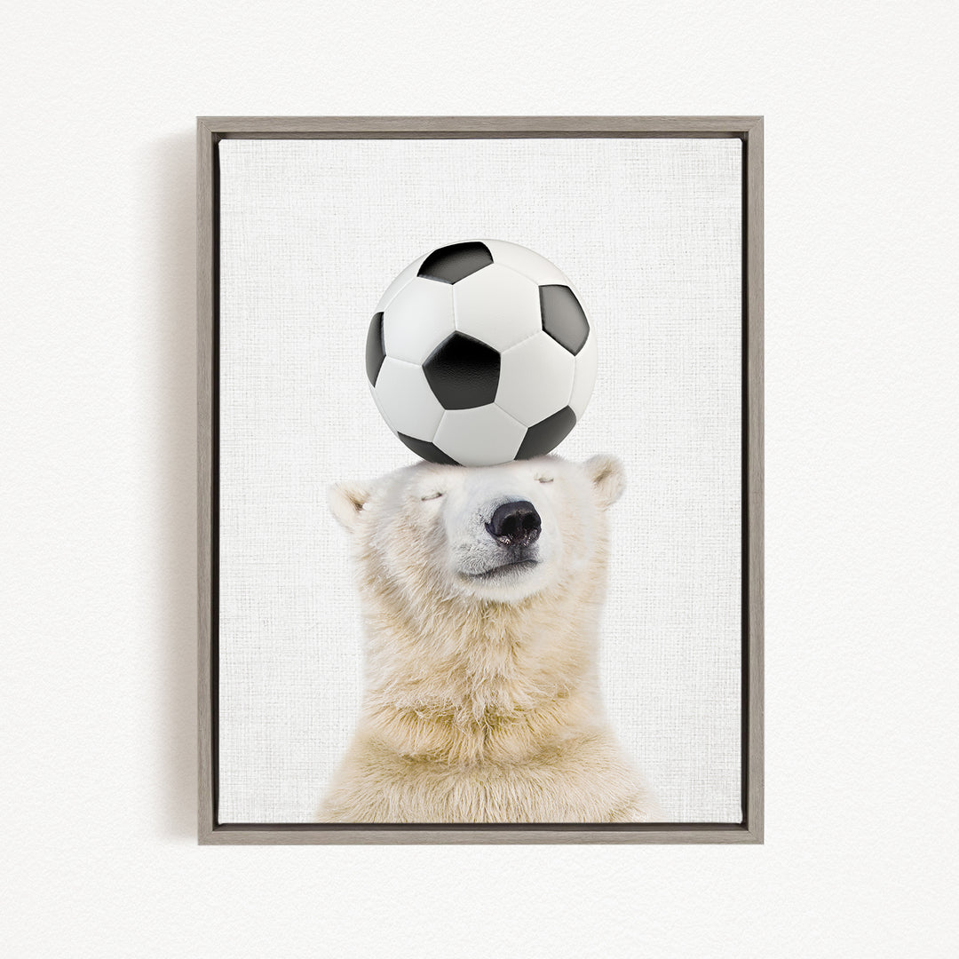 A polar bear balancing a soccer ball on its head.