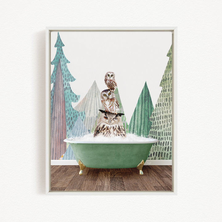 A framed print depicting three owls sitting in a green bathtub, with a forest-themed background.