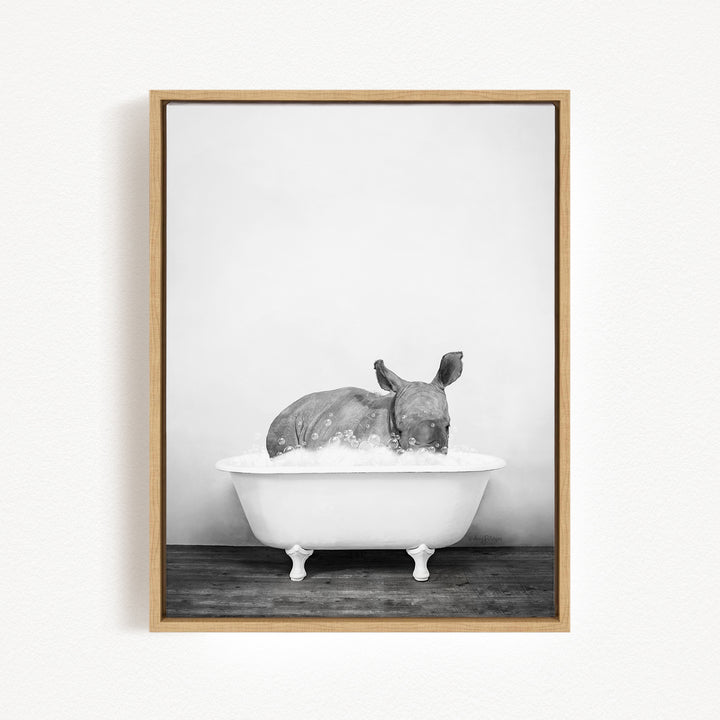 A rhinoceros is sitting in a bathtub filled with water, creating a whimsical and playful scene.