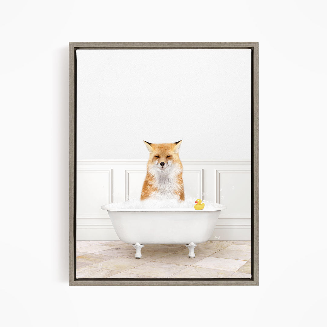 A red fox is sitting in a white bathtub filled with water, with a rubber duck floating in the tub.