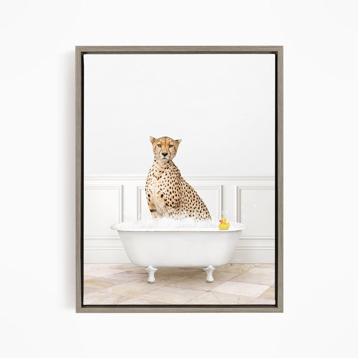 A cheetah sitting in a white bathtub filled with water, with a rubber duck floating in the water.