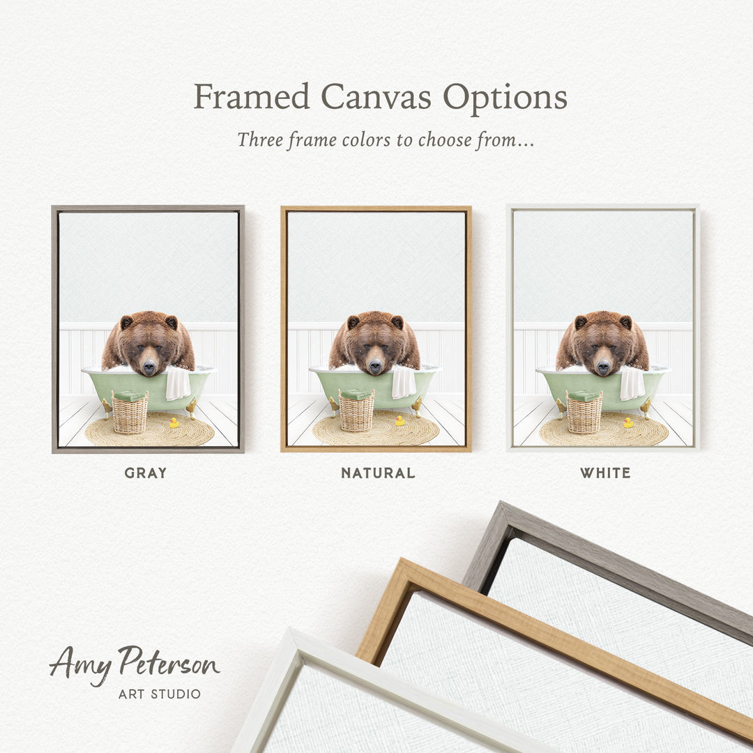 three framed canvas options, each featuring a brown bear sitting in a bathtub. The options include a gray frame, a natural frame, and a white frame.