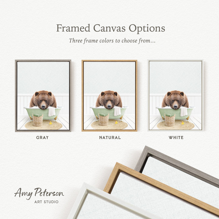 three framed canvas options, each featuring a brown bear sitting in a bathtub. The options include a gray frame, a natural frame, and a white frame.