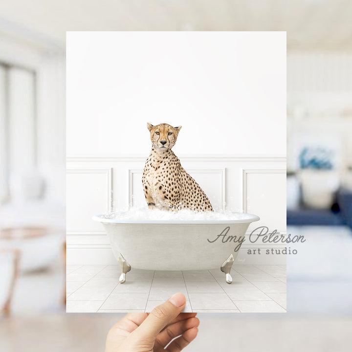 a hand holding up a photo of a cheetah in a bathtub